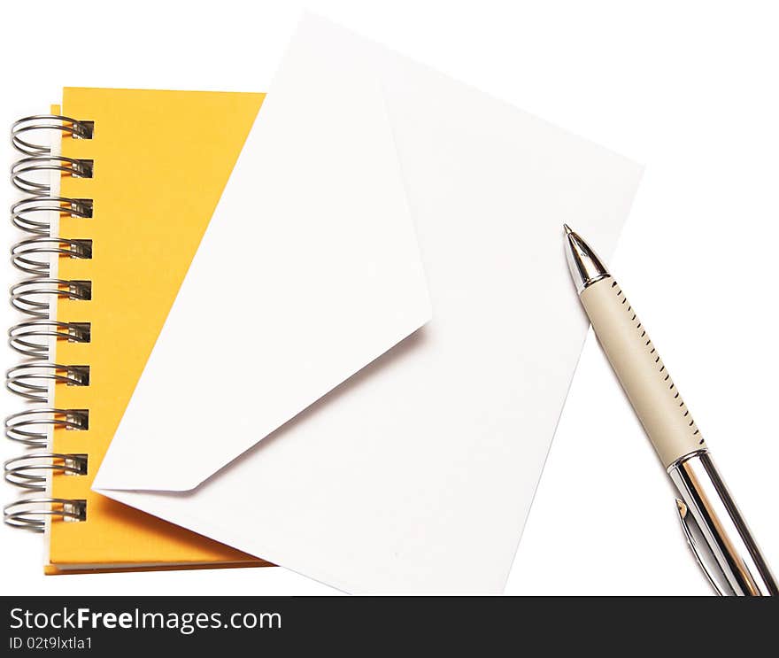 White envelope spiral notepad and pen isolated on a white