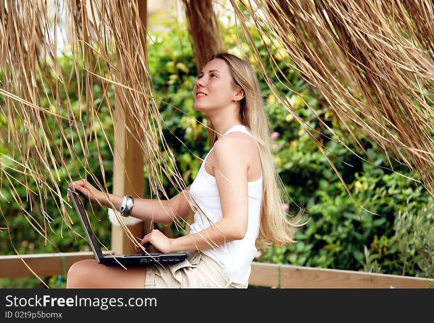 Beautiful young woman outdoors in the summer day.