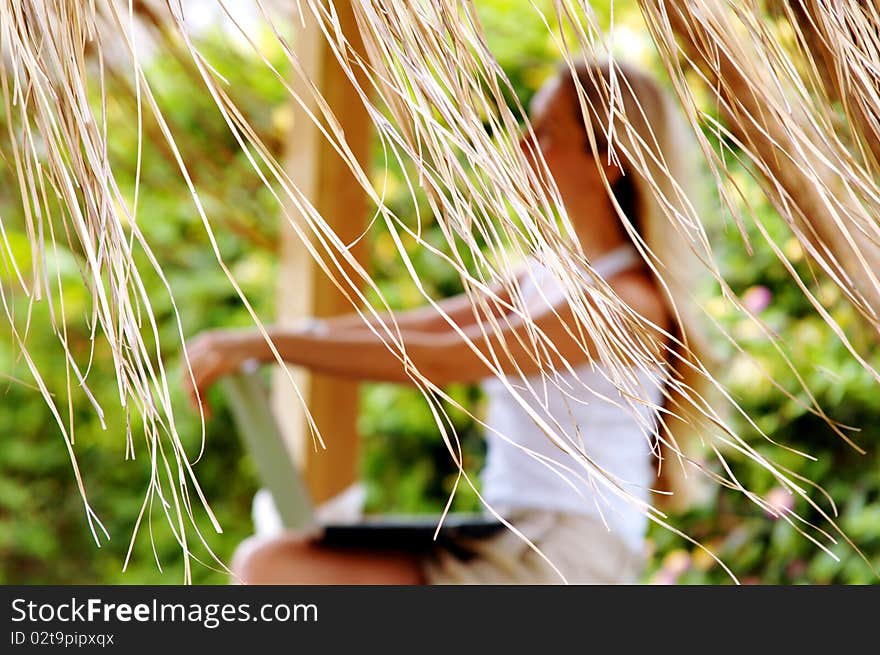 Beautiful young woman outdoors in the summer day.