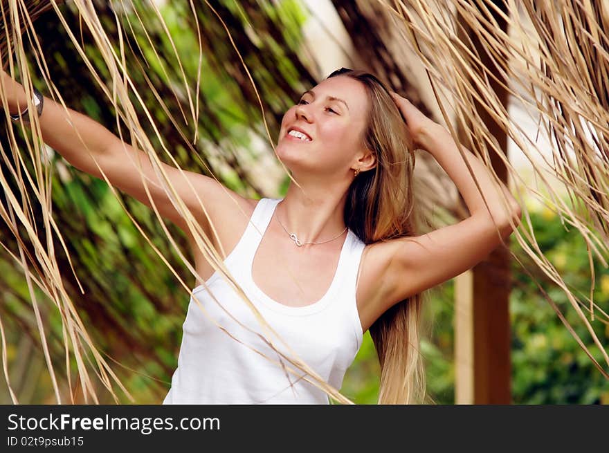 Beautiful young woman outdoors in the summer day.