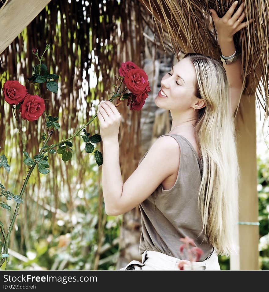 Beautiful young woman outdoors in the summer day.