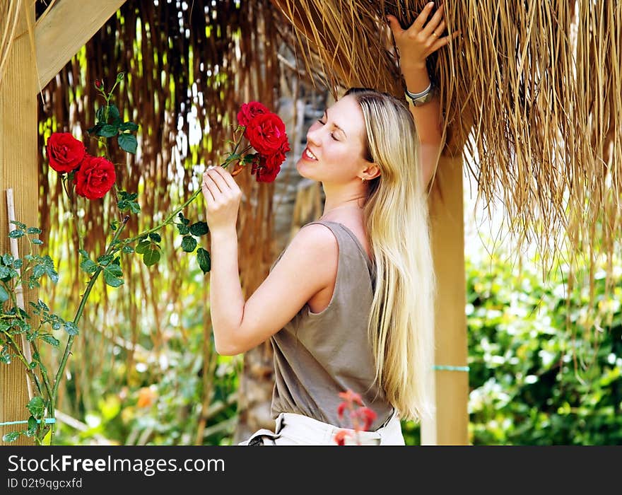 Beautiful young woman outdoors in the summer day.