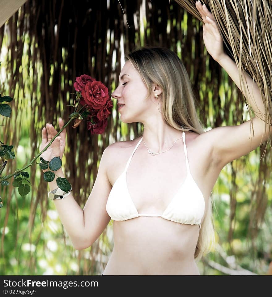 Beautiful young woman outdoors in the summer day.