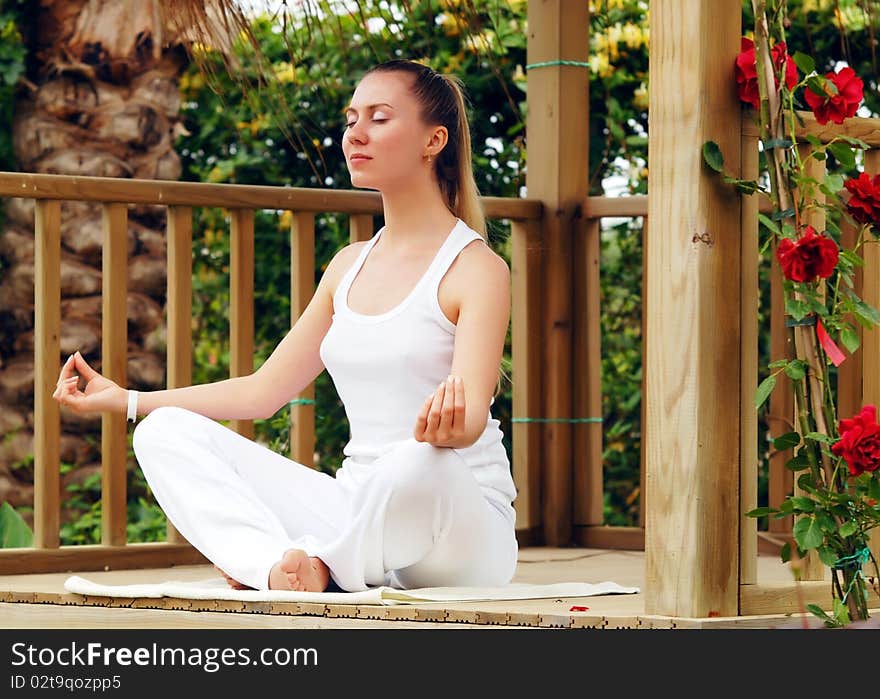 Beautiful young woman outdoors in the summer day.