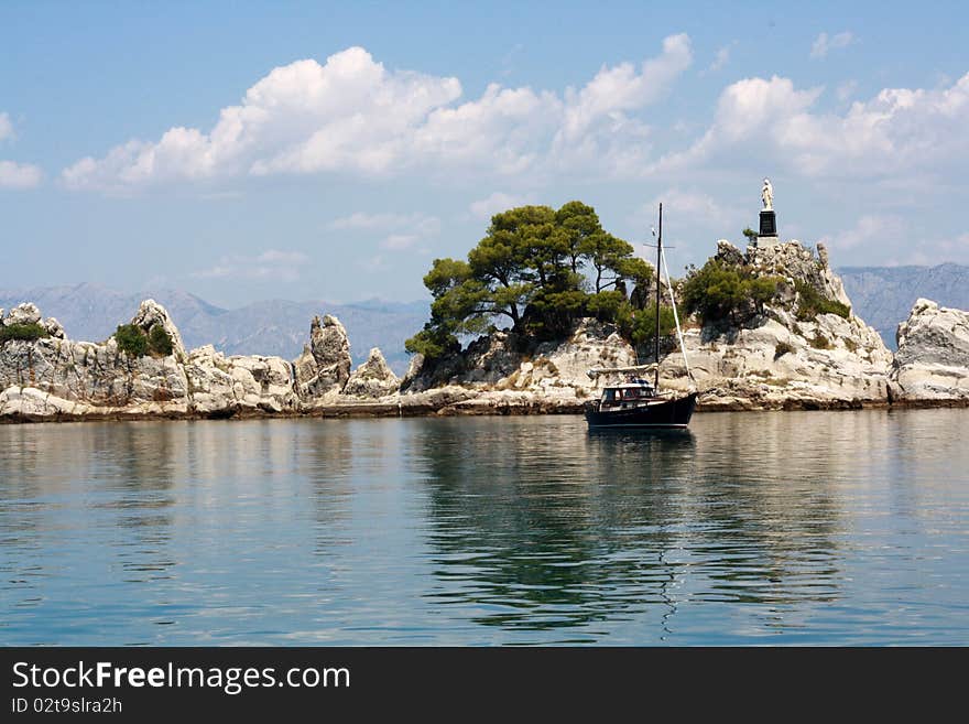 Landscape in the port Trpanj with white rocks and Statue of Holy Lady. Landscape in the port Trpanj with white rocks and Statue of Holy Lady