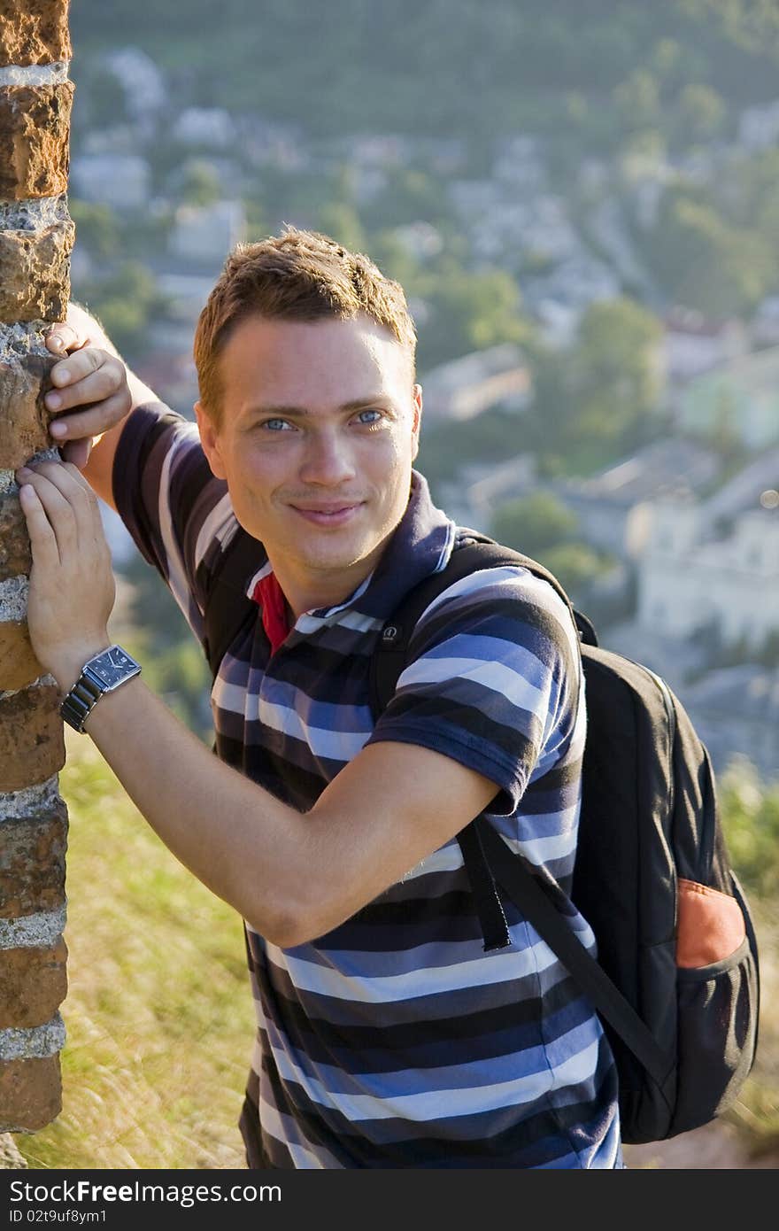 Smiling man standing against the wall. Smiling man standing against the wall