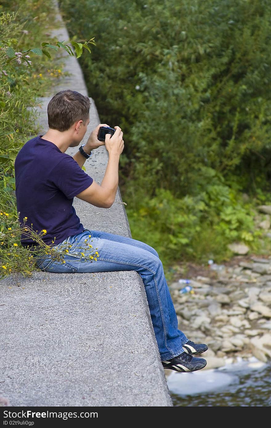 Man making a photo on his compact photocamera. Man making a photo on his compact photocamera