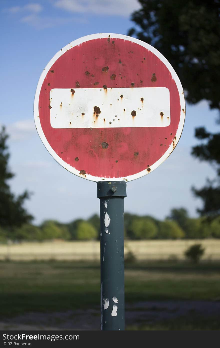 Rusty no entry sign in a field