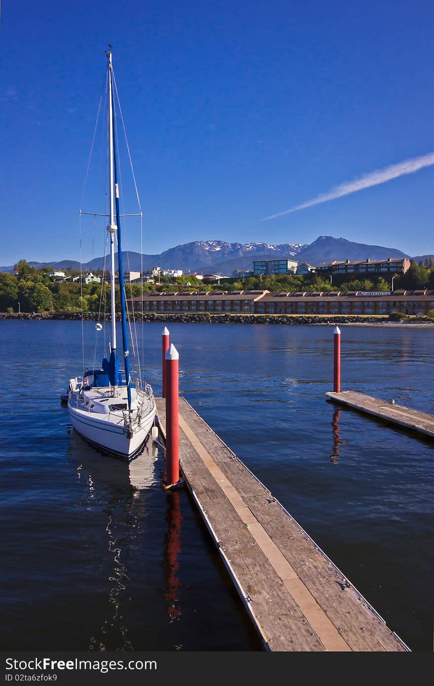 A Sailing Boat with Mountains and Water. A Sailing Boat with Mountains and Water