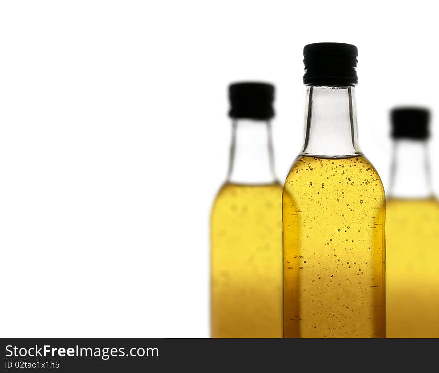 Three bottles of a yellow fizzy drink, isolated on white background, with a shallow depth of field. Three bottles of a yellow fizzy drink, isolated on white background, with a shallow depth of field.