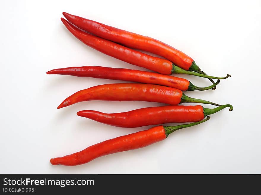 Red hot chili peppers in white background.