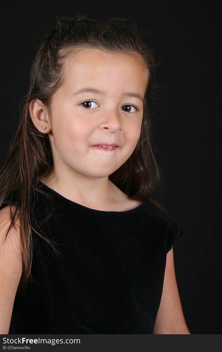 Cute little brunette girl against a black background. Cute little brunette girl against a black background