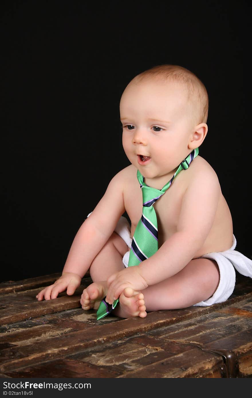 Cute caucasian baby wearing just a tie and diaper. Cute caucasian baby wearing just a tie and diaper