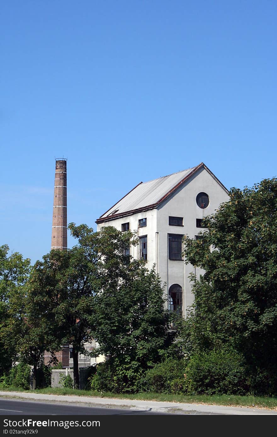 Old factory sawmill with tall chimney. Old factory sawmill with tall chimney