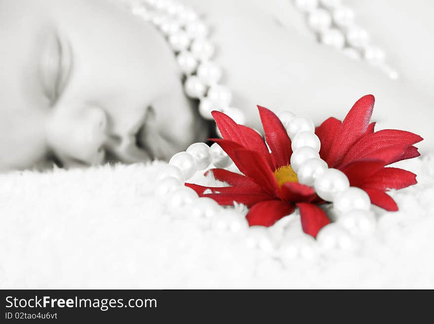 Beautiful baby girl sleeping, pearls draped with flower. FOCUS ON FLOWER AND PEARLS. Beautiful baby girl sleeping, pearls draped with flower. FOCUS ON FLOWER AND PEARLS.