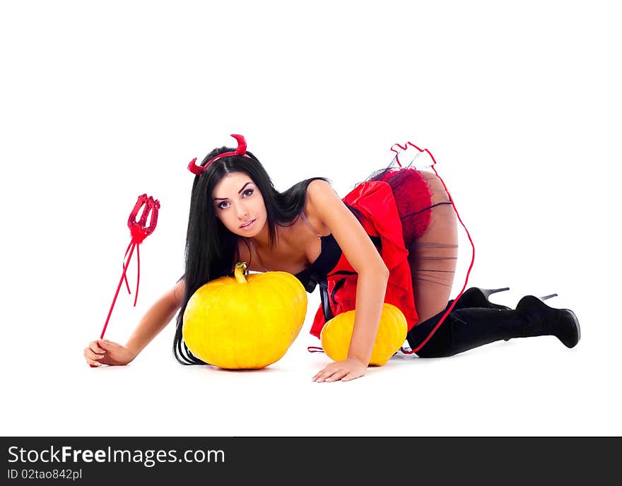 young brunette woman dressed as an imp with pumpkins. young brunette woman dressed as an imp with pumpkins