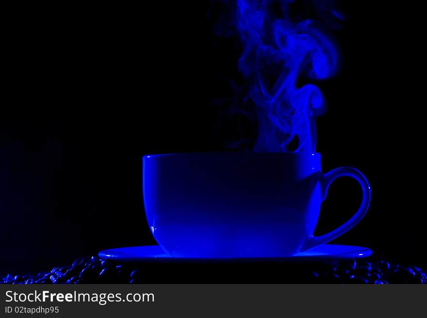 Coffee cup with steam on black background