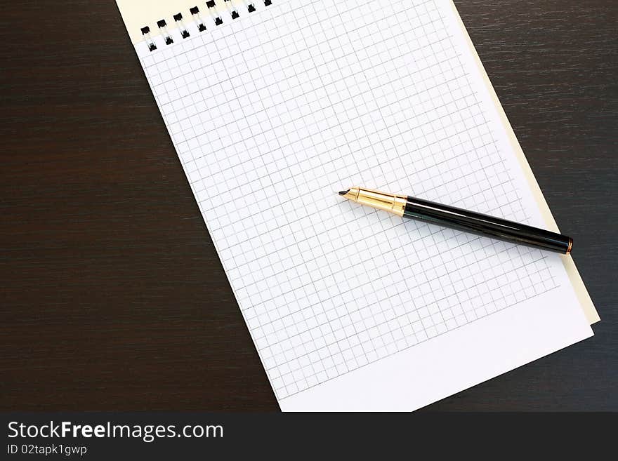 Fountain pen and notebook on the table. Fountain pen and notebook on the table