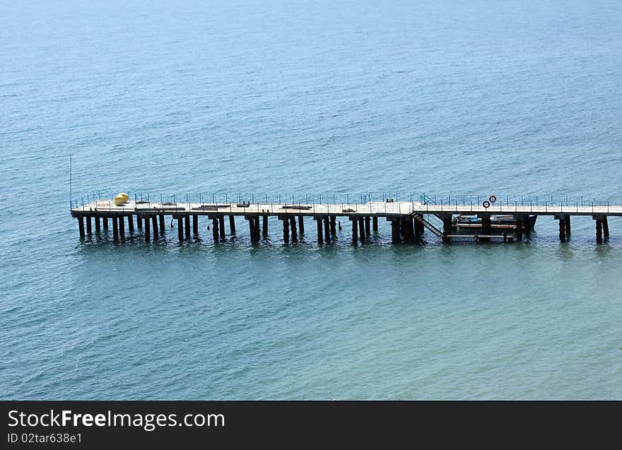 Pierce for mooring boats and yachts off the coast of Feodosia in Crimea