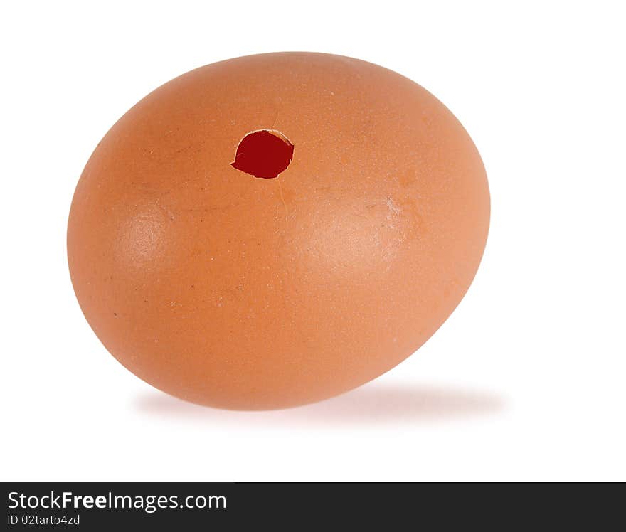 Small hole in an egg isolated over white. Small hole in an egg isolated over white.