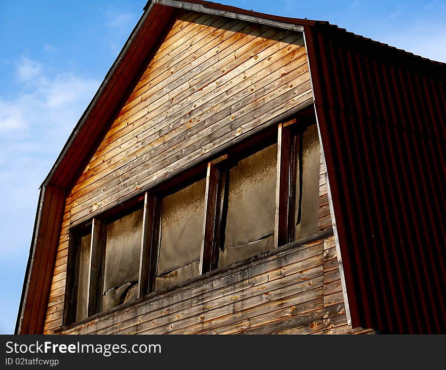 The old wooden house against the dark blue sky. The old wooden house against the dark blue sky.