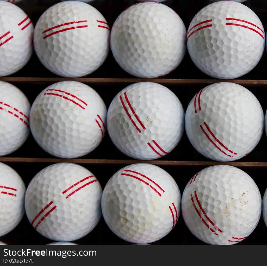 Golf balls on tray ready to drive