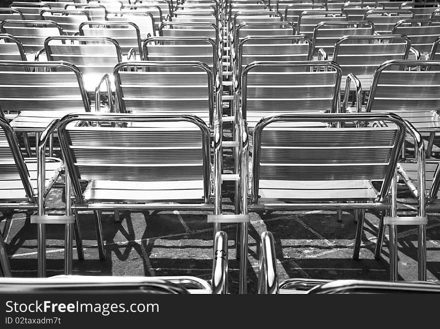 Auditorium full of shiny metal chairs background. Auditorium full of shiny metal chairs background