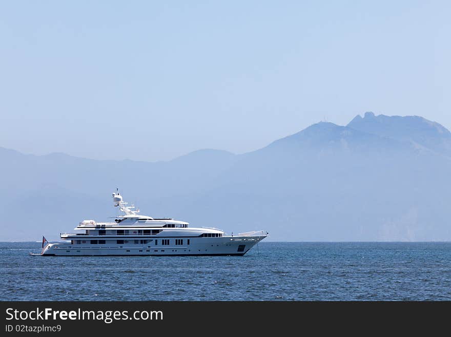 Large white motor yacht anchored in the bay mountain. Large white motor yacht anchored in the bay mountain