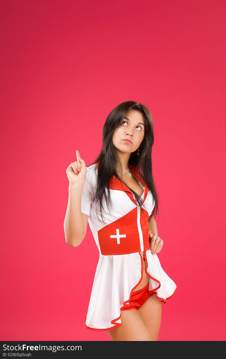 Sensual brunette nurse posing on color background