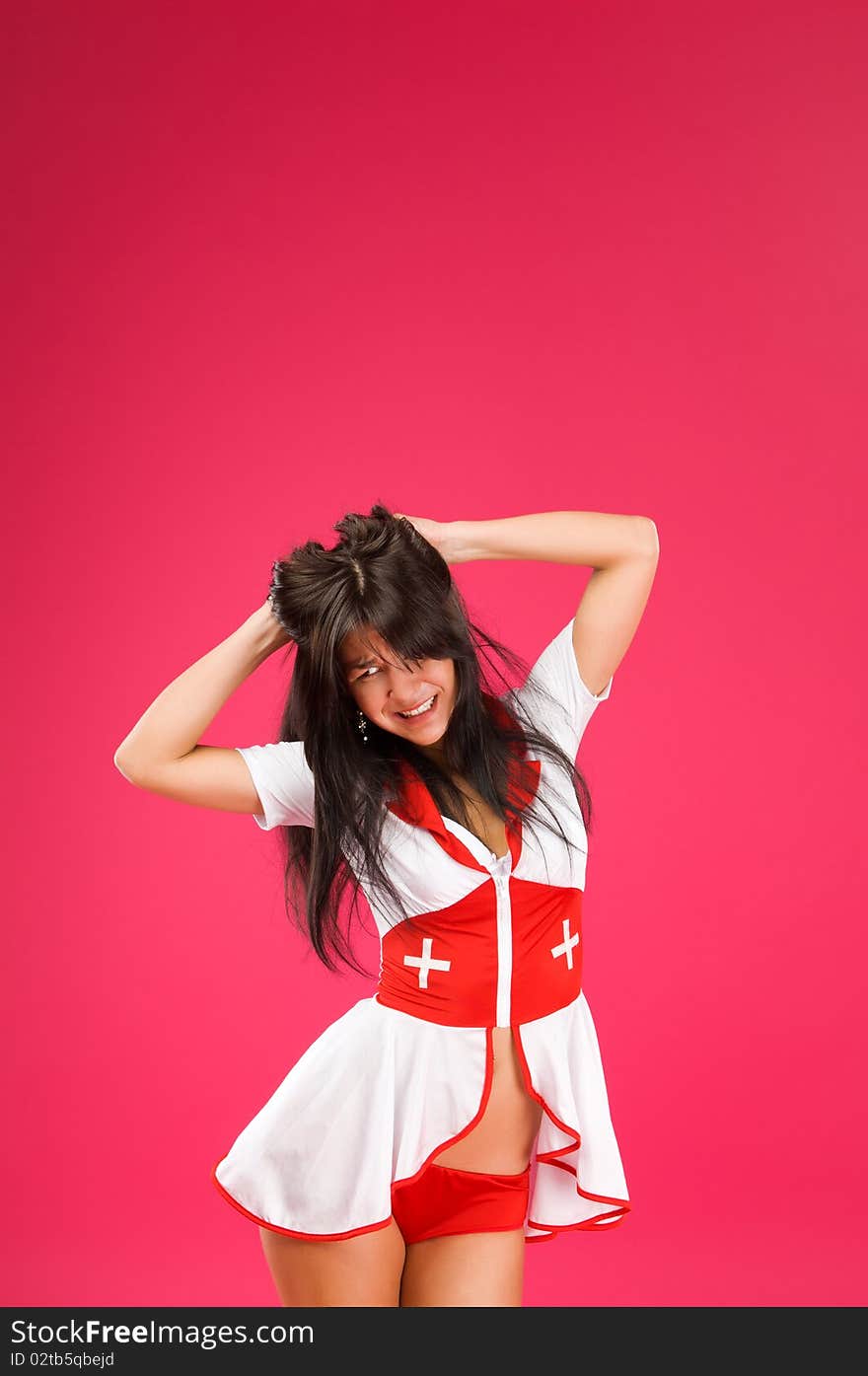 Sensual brunette nurse posing on color background