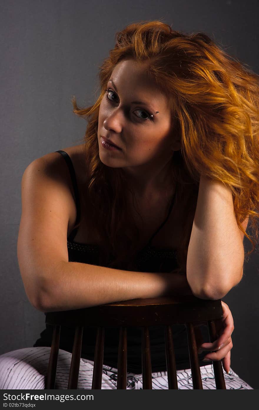 Portrait of beautiful redhaired woman on a dark background. Portrait of beautiful redhaired woman on a dark background