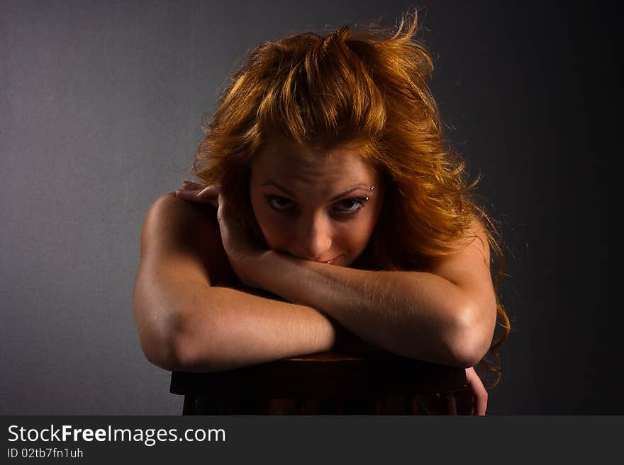 Portrait of beautiful red-haired woman on a dark background. Portrait of beautiful red-haired woman on a dark background