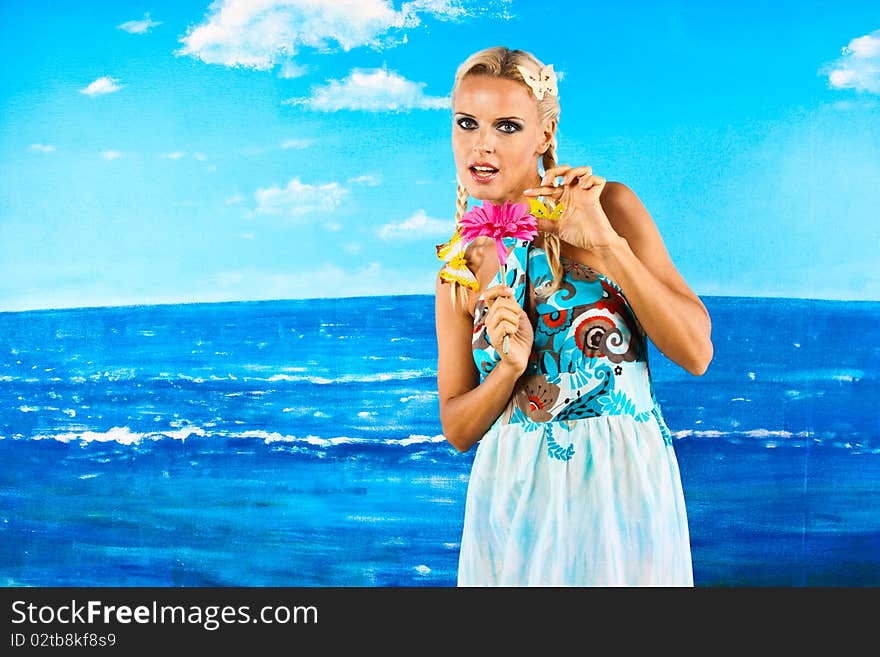 Dreaming woman with flower in the background of the sea. Dreaming woman with flower in the background of the sea