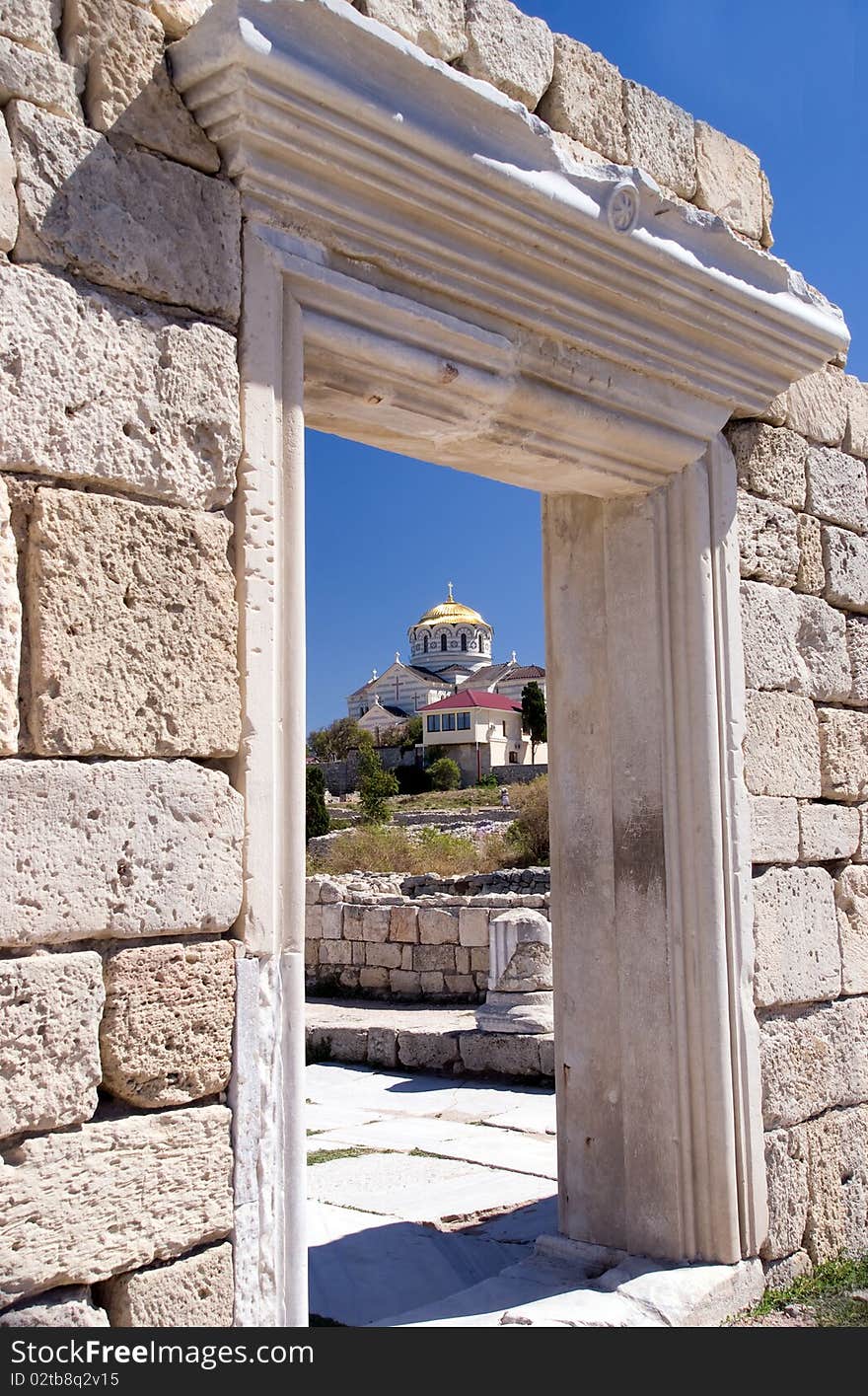 Ancient ruins against orthodox church