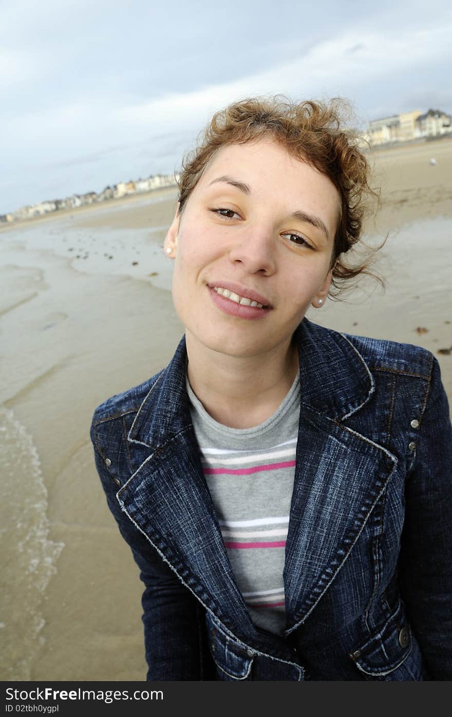 Young woman walking at the beach at low tide in Saint-Malo, France. Young woman walking at the beach at low tide in Saint-Malo, France