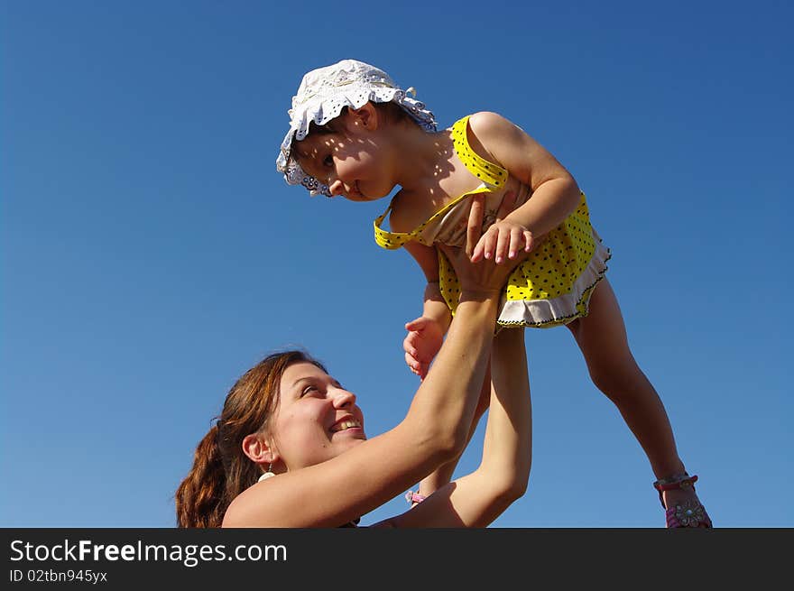 Mum lifts the daughter on hands. Mum lifts the daughter on hands