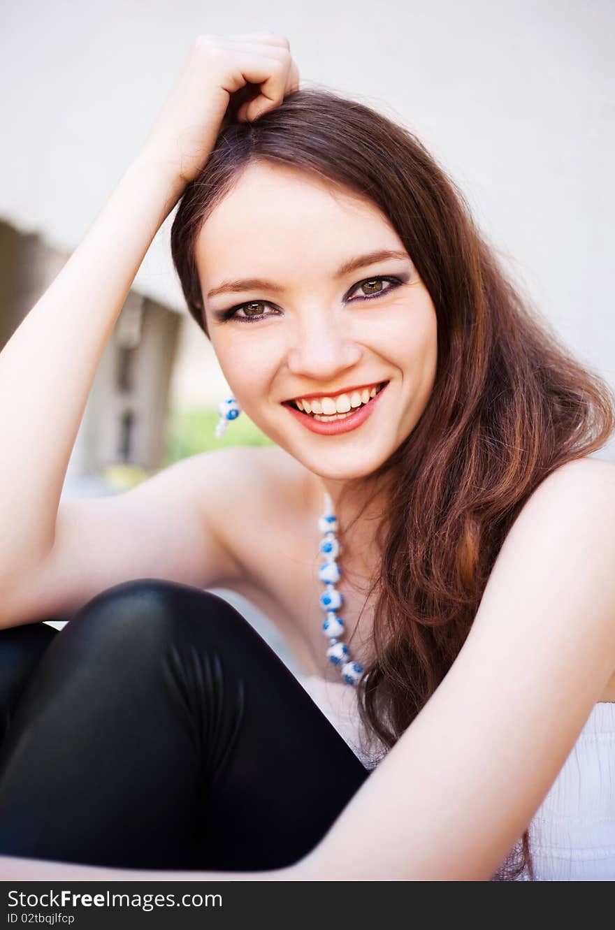 Portrait of a happy young laughing girl outdoor in summertime