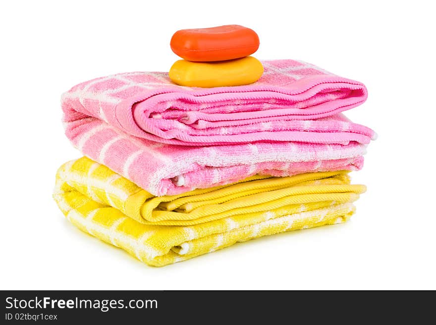 Towels and piece of soap isolated on white background. Towels and piece of soap isolated on white background