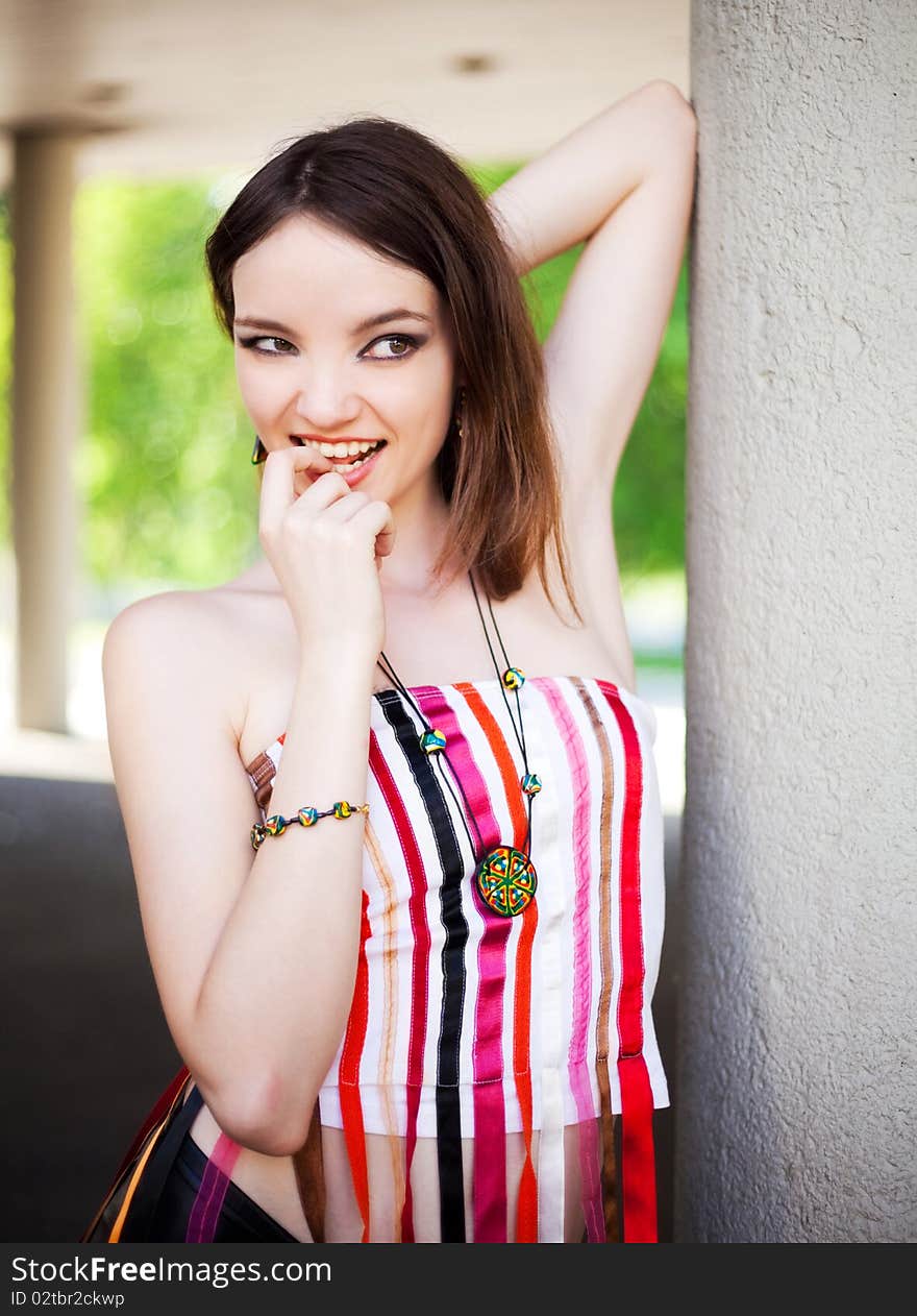 Portrait of a beautiful young brunette model wearing beads