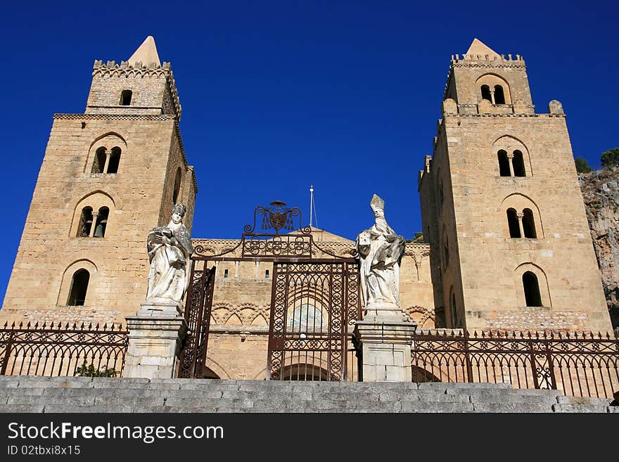 Cefalu ancient norman cathedral towers on blue summer sky, Island of Sicily - Italy. Cefalu ancient norman cathedral towers on blue summer sky, Island of Sicily - Italy