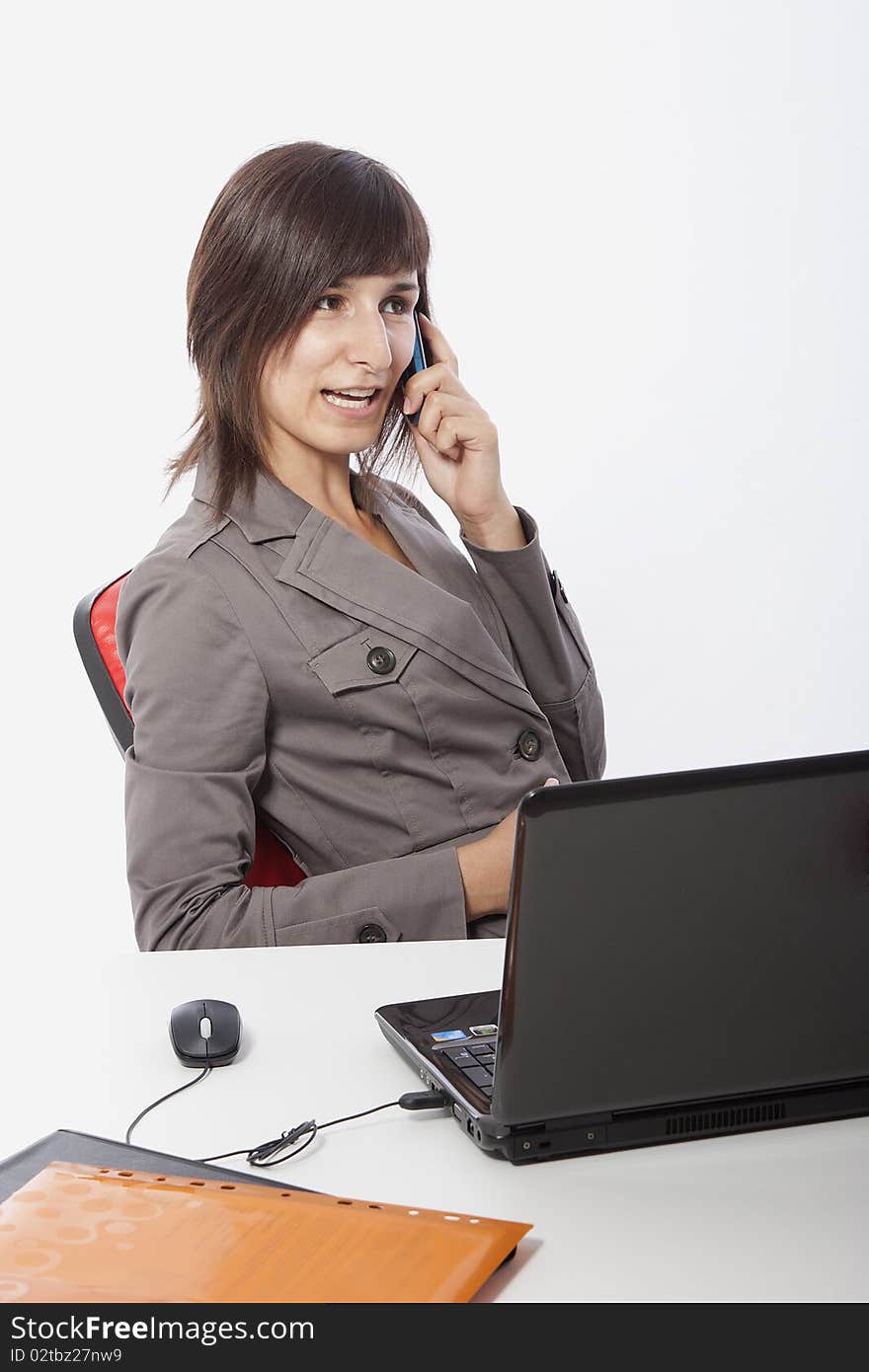 This photo shows a business woman talking on the phone.