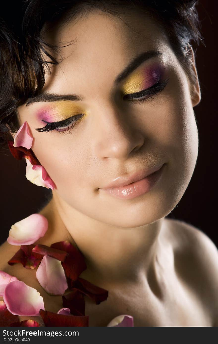 Portrait of a girl with beautiful make-up and rose petals. Portrait of a girl with beautiful make-up and rose petals