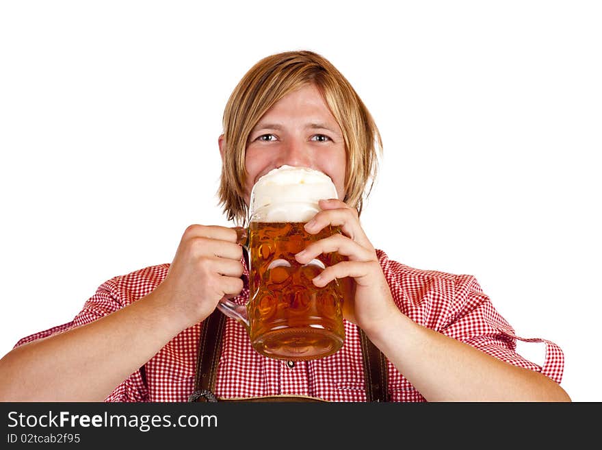 Happy Bavarian man drinks out of oktoberfest beer stein. Isolated on white background.