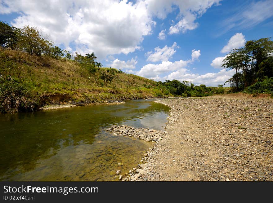 River and green nature with white clouds. Dominican Republic. River and green nature with white clouds. Dominican Republic.