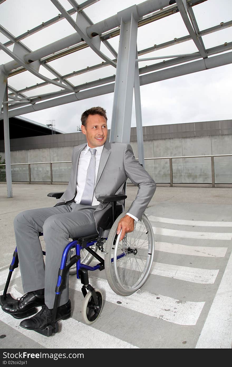 Businessman in wheelchair waiting for a taxi. Businessman in wheelchair waiting for a taxi