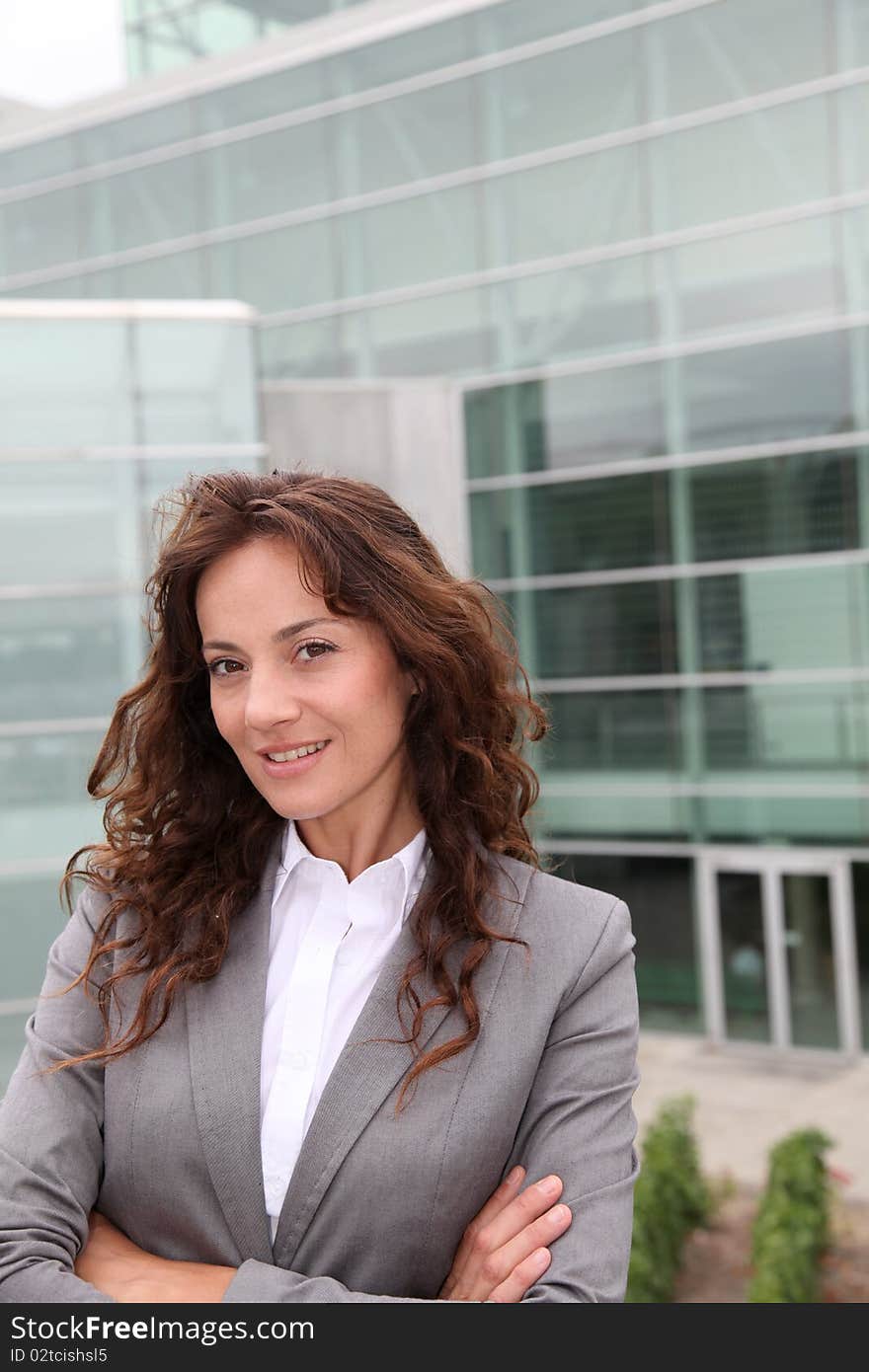 Businesswoman standing in front of modern building. Businesswoman standing in front of modern building