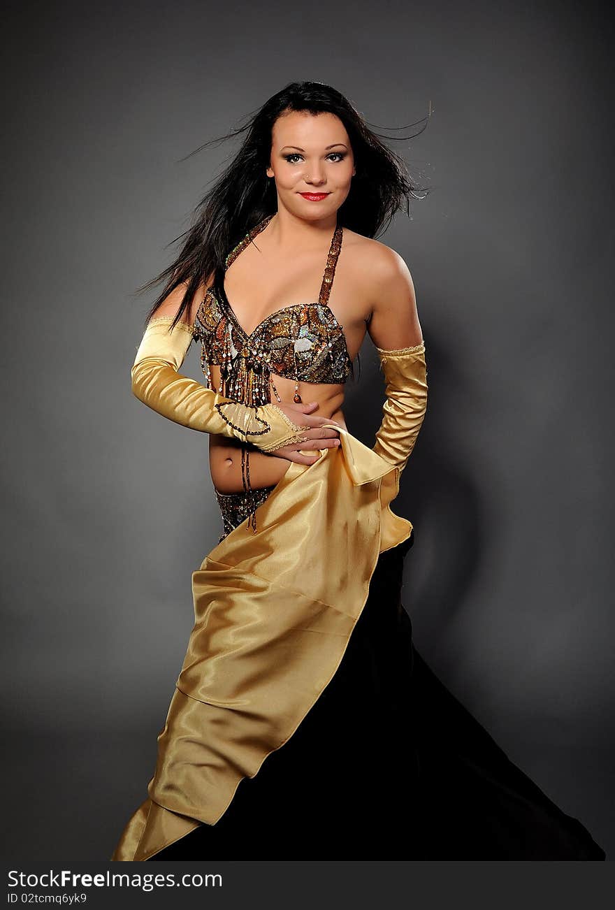 Beautiful dancer woman in bellydance costume with pretty professional stage make-up