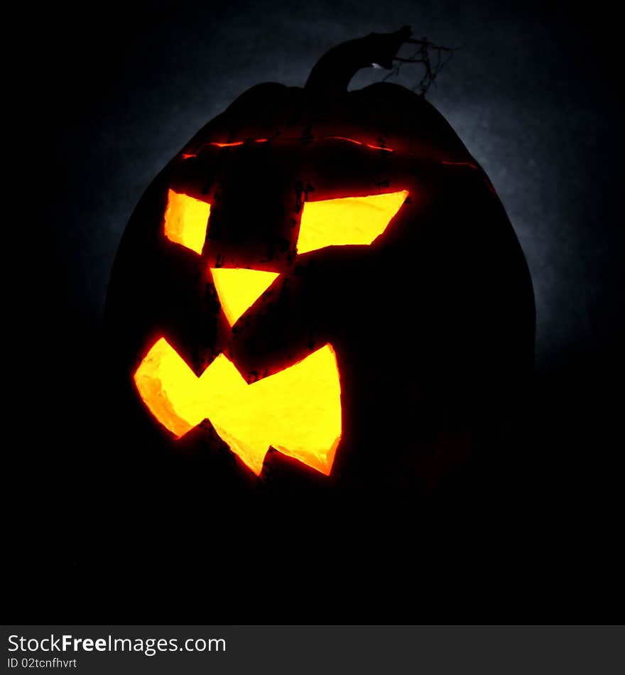 Illuminated Jack-o-lantern glowing on black background