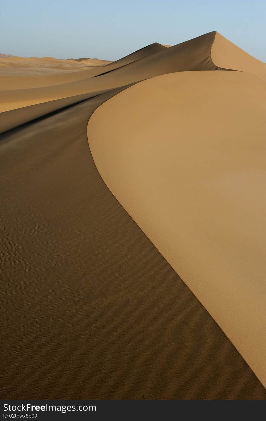 Landscape of desert sand dunes that streches into the horizon. Landscape of desert sand dunes that streches into the horizon.