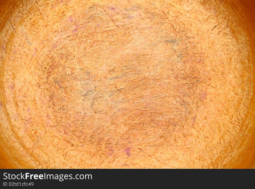 The bottom of an old wooden bowl, used for chopping vegetables, can be used as a background. The bottom of an old wooden bowl, used for chopping vegetables, can be used as a background.